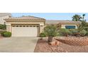 Single story home with a neutral color scheme, well-manicured desert landscaping, and an attached two-car garage at 10800 Brinkwood Ave, Las Vegas, NV 89134