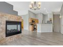 Open-concept living area featuring a fireplace and hardwood floors, leading into the kitchen at 1162 Red Margin Ct # 101, Las Vegas, NV 89183
