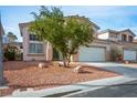 Inviting two-story home with a manicured front yard and a spacious two-car garage at 1163 Regal Lily Way, Las Vegas, NV 89123