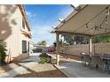Cozy backyard featuring a covered patio with string lights and a dining set at 1705 Desert Ridge Ave, North Las Vegas, NV 89031