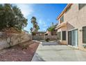 The backyard has a patio with seating, garden, and gravel area at 1705 Desert Ridge Ave, North Las Vegas, NV 89031