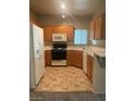Functional kitchen with wooden cabinets and essential appliances at 1830 Buffalo Dr # 2083, Las Vegas, NV 89128