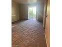 Cozy living room with neutral carpeting and a sliding glass door at 1830 Buffalo Dr # 2083, Las Vegas, NV 89128