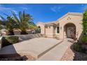 A quaint single-story home featuring a well-kept front yard and desert landscaping with a paved patio at 1908 Oliver Springs St, Henderson, NV 89052