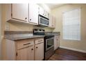 Bright kitchen with stainless steel oven, granite countertops, and wood flooring at 231 W Horizon Ridge Pkwy # 314, Henderson, NV 89012