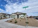 Charming single-story home with desert landscaping, a two-car garage, and clear street signage at 247 Desoto Falls St, Indian Springs, NV 89018