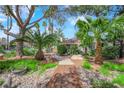 Picturesque walkway surrounded by palm trees and lush greenery at 2714 Bridgepointe Dr, Las Vegas, NV 89121