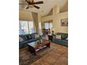 Cozy living room with plush sofas, a decorative rug, and bright natural light from large windows at 2750 Sandalwood Ave, Henderson, NV 89074