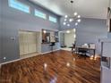 Open floor plan with hardwood floors, vaulted ceiling, modern light fixture, and pass through to kitchen at 3145 E Flamingo Rd # 2005, Las Vegas, NV 89121