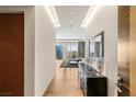 Bright, modern hallway featuring hardwood floors, light walls, and an entrance to a living area with city views at 3750 Las Vegas Blvd # 3008, Las Vegas, NV 89158