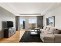 Inviting living room featuring a comfortable sectional couch, city views, and modern decor at 3750 Las Vegas Blvd # 3008, Las Vegas, NV 89158
