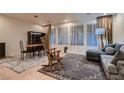Open-concept living and dining area featuring tile floors, neutral walls, and lots of natural light at 379 Fynn Valley Dr, Las Vegas, NV 89148