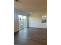 Spacious living room with wood flooring and sliding glass door to the backyard at 4145 Texas Lilac Ave, Las Vegas, NV 89139