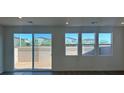 Bright living room with large windows and a sliding glass door leading to backyard at 4153 Texas Lilac Ave, Las Vegas, NV 89139