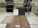 Detailed kitchen design showcasing luxury vinyl plank flooring, neutral quartz countertop, stainless steel appliances and stylish cabinetry at 4282 Yucca Brevi Ave, Las Vegas, NV 89139