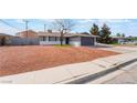 Charming single-story home featuring gray paint, desert landscaping, and a two-car garage at 4857 Fairfax Ave, Las Vegas, NV 89120