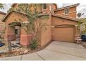 Inviting two-story home featuring a one car attached garage and well-manicured landscaping at 5050 Secret Rock St, Las Vegas, NV 89122