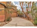 Attached one-car garage with a private drive and drought tolerant desert landscaping at 5050 Secret Rock St, Las Vegas, NV 89122