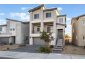 Modern home featuring a two-story facade, private balcony, and a paved driveway for curb appeal at 5745 Becklow Gardens Ave, Las Vegas, NV 89141
