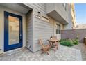Inviting front entrance with blue door, patio seating, and well-maintained landscaping at 651 Sentinel Spire St, Las Vegas, NV 89138