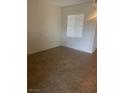 A bright, empty bedroom with tiled floors, a window with blinds, and neutral walls at 6868 Sky Pointe Dr # 1034, Las Vegas, NV 89131
