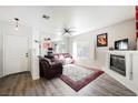 Inviting living room boasts fireplace, neutral walls, wood floors and ample natural light at 6901 Squaw Mountain Dr # 201, Las Vegas, NV 89130