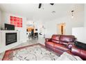 Bright living room featuring an inviting fireplace, a modern ceiling fan and neutral colored walls at 6901 Squaw Mountain Dr # 201, Las Vegas, NV 89130