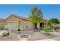 Well-maintained single-story house featuring desert landscaping, a front porch, and a two-car garage at 713 Salt Flats Cir, Henderson, NV 89011