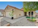 Cozy single-story home with a front porch, xeriscaping, and a two-car garage at 713 Salt Flats Cir, Henderson, NV 89011