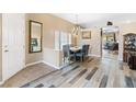 Elegant dining room features modern light fixture, comfortable seating, and seamless flow into the living space at 7348 Zion Falls St, Las Vegas, NV 89131