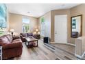 Inviting living room with hardwood floors and high windows, showcasing a comfortable seating area and natural light at 7348 Zion Falls St, Las Vegas, NV 89131