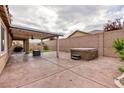 Private backyard featuring a covered patio and hot tub, perfect for outdoor relaxation at 7525 Campbell Ranch Ave, Las Vegas, NV 89179