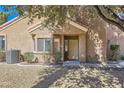 Inviting front entrance with a cozy porch, well-maintained landscaping, and a modern AC unit at 7636 Sudan Ct, Las Vegas, NV 89149