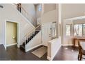 Welcoming foyer featuring hardwood floors, a staircase, and lots of natural light from nearby windows at 7636 Sudan Ct, Las Vegas, NV 89149