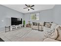 Cozy living room with comfortable seating, entertainment center, and lots of light at 788 Grand Country Ave, North Las Vegas, NV 89086