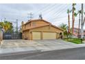 Two-story home with a three-car garage and a tile roof showing curb appeal at 8504 Soneto Ln, Las Vegas, NV 89117