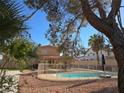 Backyard pool with fenced area and a charming tiki hut creating a relaxing outdoor oasis at 8504 Soneto Ln, Las Vegas, NV 89117