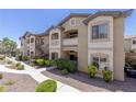 Well-maintained apartment building with a manicured lawn and pedestrian walkways at 8805 Jeffreys St # 1018, Las Vegas, NV 89123