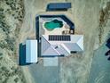 Aerial view of the property showcasing the pool, house, and solar panels at 881 W Kathryn Ave, Pahrump, NV 89060