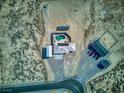 Aerial view of the home, outbuildings, pool and desert landscaping at 881 W Kathryn Ave, Pahrump, NV 89060