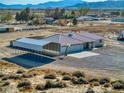 Exterior elevation showing detached garage and desert landscape at 881 W Kathryn Ave, Pahrump, NV 89060