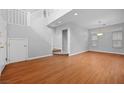 Spacious living room featuring gleaming hardwood floors and a staircase at 9107 Wine Cellar Ave, Las Vegas, NV 89148