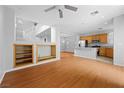 Open-concept living space with hardwood floors, built-in shelving, and a staircase at 9107 Wine Cellar Ave, Las Vegas, NV 89148