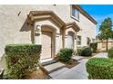 Inviting home entrance with a charming front door and manicured bushes at 9322 Straw Hays St # 101, Las Vegas, NV 89178