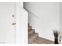 Bright stairway with modern wood laminate flooring and white walls at 9322 Straw Hays St # 101, Las Vegas, NV 89178