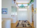 Bright foyer features a soaring ceiling, double front doors, and decorative accents at 10720 Bennington Ct, Las Vegas, NV 89134
