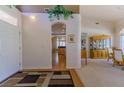 Inviting foyer with archway, chandelier, and views into the living and dining areas at 10720 Bennington Ct, Las Vegas, NV 89134