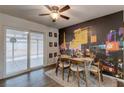 Dining room featuring a modern table and a Las Vegas-themed mural wall at 117 Saint Albans Ct, Henderson, NV 89015