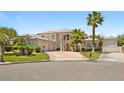 Elegant two-story home with a three-car garage, circular driveway and lush landscaping for curb appeal at 1601 Fairgate Ct, Las Vegas, NV 89117