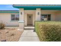 Charming front entrance with a decorative door, manicured shrubbery, and stylish outdoor sconces at 1720 S Blagg Rd, Pahrump, NV 89048